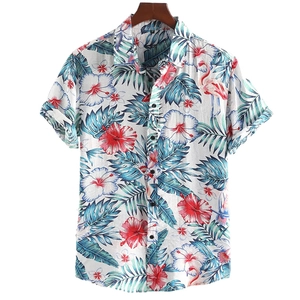 Detail of tropical summer shirt featuring red hibiscus flowers and pink flamingo prints