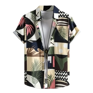 Close-up of tropical leaf print and geometric color blocks on a men's summer beach shirt