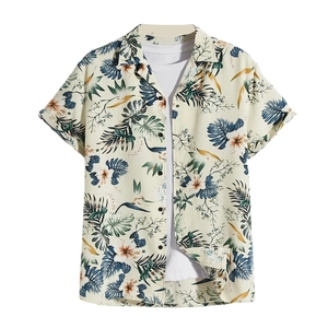 Detail of tropical palm leaf and flower print on men's beige short sleeve beach shirt