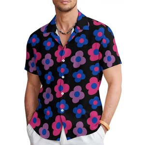 Detail of tropical floral print on black short-sleeve shirt with white buttons