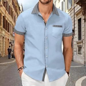 Detail of light blue men's shirt showing houndstitch patchwork on the collar and pocket