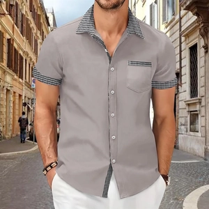 Detail of men's short sleeve shirt showing houndstooth patchwork on collar and pocket