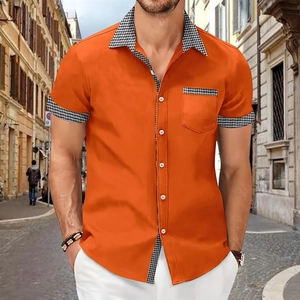 Detail of orange shirt showing houndstooth collar stitching and single chest pocket design