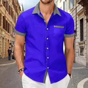 Close-up of royal blue short sleeve shirt with black and white houndstooth patchwork details