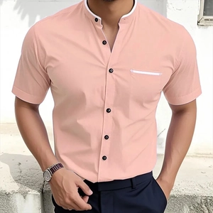 Detail of light pink slim-fit stand collar shirt with contrast white piping and black buttons