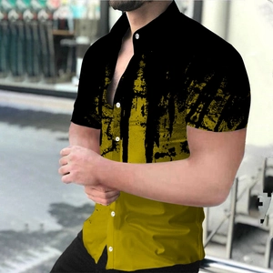 Detail of men's casual short sleeve shirt featuring a bold black and yellow ink splash design