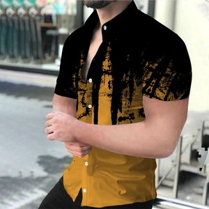 Close-up of men's casual shirt featuring artistic yellow ink splash print on black fabric
