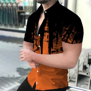 Detail of men's casual shirt featuring black and orange color block with paint splash print