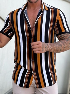 Detail of men's casual vertical stripe shirt with yellow, black, and white patterns