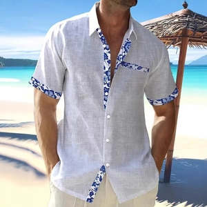 Detail of men's short sleeve shirt featuring blue floral trim on placket and pocket