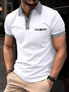 Detail of white men's polo shirt featuring plaid accents on collar and faux pocket