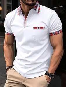 Detail of men's white polo shirt featuring red plaid patterns on the collar and pocket