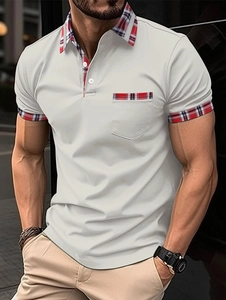 Detail view of the tricolor plaid trim on the collar and pocket of this men's polo shirt