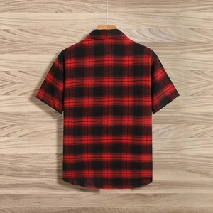 Rear view of a red and black checkered short sleeve shirt on a wooden hanger