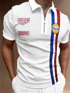 Detail of white polo shirt with Gulf and Firestone racing patches and zipper neckline
