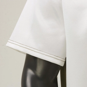 Detail of white waffle knit polo shirt sleeve with durable double-needle stitching