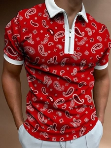 Detailed macro view of white zipper closure and paisley print on red men's polo shirt