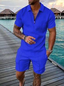 Detailed view of men's blue short sleeve polo set with textured geometric knit fabric