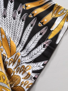 Close-up of artistic feather print on men's holiday shirt showing premium sewing detail