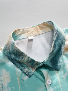 Detailed close-up of abstract teal and yellow print fabric on men's holiday shirt