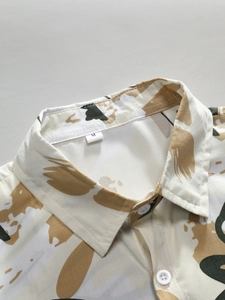 Detail of men's resort shirt with camo pattern, collar size tag and white buttons