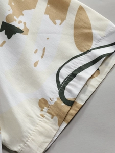 Macro shot of fabric texture and neat double-needle stitching on men's printed shirt
