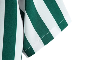 Detailed close-up showing green and white striped shirt cuff with fine stitching