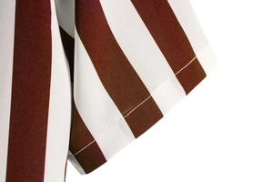 Close-up detail of red and white striped shirt sleeve with precision double stitching