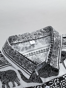 Detailed macro view of the shirt collar with M size label and bohemian elephant print