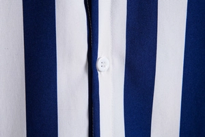 Close-up of blue and white vertical striped shirt featuring a white button and neat stitching