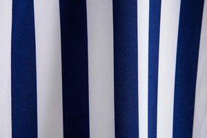 Detailed macro view of the blue and white vertical stripe cotton blend shirt fabric
