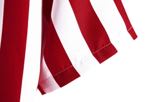 Detail of red and white striped shirt fabric with high-quality stitching and seamed edges