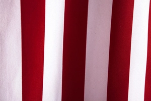 Macro view of the high-quality red and white vertical striped fabric on the men's shirt