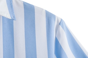 Macro detail of vertical blue and white striped shirt with premium woven fabric texture