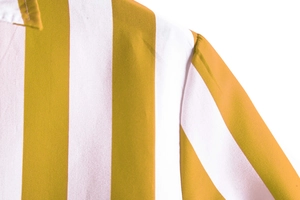 Detailed view of yellow and white vertical striped shirt fabric and shoulder stitching