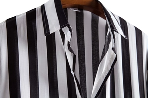 Close-up of black and white striped shirt neckline with collar and white buttons