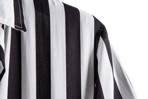 Detail of classic black and white vertical striped shirt featuring a neat turnover collar