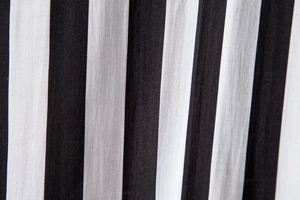 Macro view of vertical black and white striped fabric texture with fine weave details