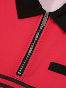 Détail d'un polo rouge avec fermeture à glissière en métal et col noir texturé