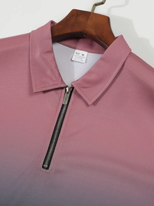 Detail of metal zipper neck on a pink to grey gradient polo shirt with knit texture