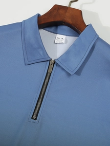 Detail of blue men's polo shirt featuring a metal half-zipper and honeycomb knit texture