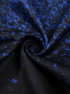 Macro view of blue and black abstract printed fabric with soft grainy texture for men's polo