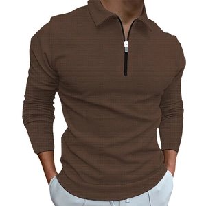 Detail of waffle knit fabric on men's long sleeve polo shirt with half-zip closure