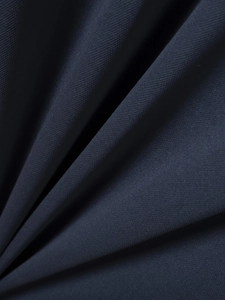 Close-up of deep blue ribbed polo shirt fabric texture with soft drapes and fine weave