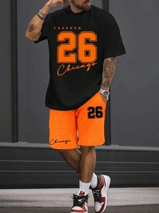 Close-up of black T-shirt and orange shorts featuring Freedom 26 Chicago printing