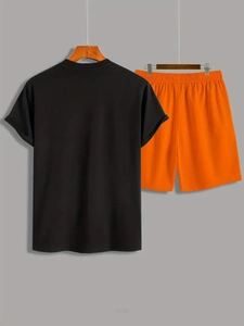 Detail of men's short sleeve black T-shirt and elastic orange shorts sports set