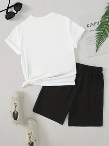 Flat lay of white t-shirt with side knot detail and black drawstring shorts set