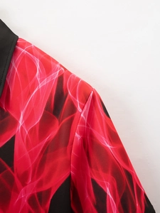 Detailed close-up of breathable mesh fabric on red and black flame pattern polo shirt