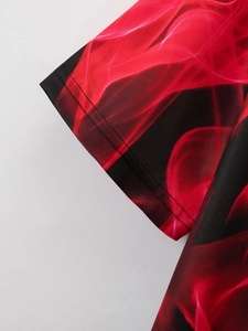 Detail of red and black flame digital print on breathable mesh fabric polo shirt sleeve