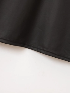 Detail shot of the hem showing reinforced double-needle stitching on a black polo shirt